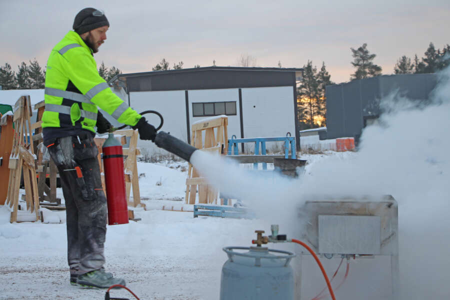 Kai Raihila harjoittelee hiilidioksidisammuttimen käyttöä.